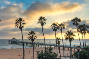 a group of palm trees on a beach with a pier at Meridian Manor in Alhambra