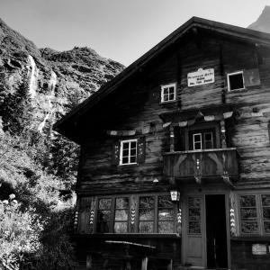 a black and white photo of an old wooden house at Grawandhütte in Ginzling
