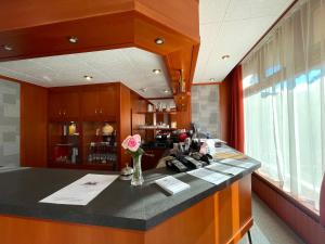 an office with a counter with flowers on it at Csipke Hotel in Kiskunhalas