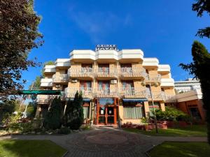 a hotel building with a sign on top of it at Csipke Hotel in Kiskunhalas