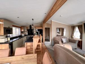 een keuken en een woonkamer in een tiny house bij Wyndham Lodge in South Cerney
