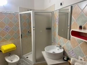 a bathroom with a shower and a sink and a toilet at L'Oasi di Chia in Chia