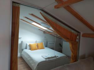 a bedroom with a bed with a glass wall at Villa Passage in Ohrid