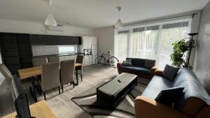 a living room with a couch and a table at Sirály apartman in Keszthely