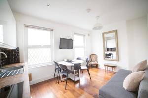 a living room with a table and a couch at Victorian Property in London