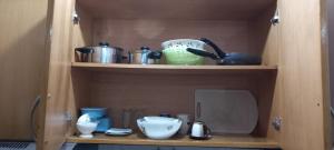 a cupboard with bowls and other kitchen items on it at Ka-Bela 2 in Sal Rei