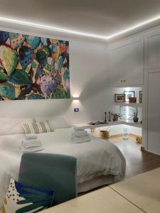 a bedroom with a bed and a painting on the wall at Lavica Di Mezzo Apartments in Catania