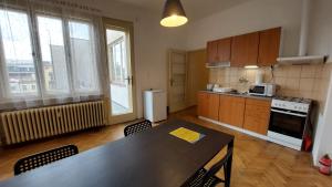 a kitchen with a table and chairs in a room at Bonvolon in Prague