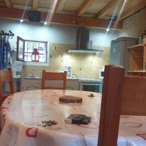 a kitchen with a table with a table cloth on it at Le chalet des nounours in Boutx