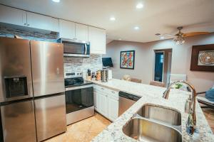 a kitchen with a stainless steel refrigerator and a sink at Fitzgerald House in Tampa