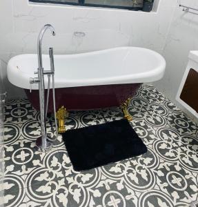 a bath tub in a bathroom with a floor at modern, two-story luxury house in Gaborone