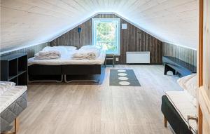 a bedroom with a bed in a attic with a window at Amazing Home In Sjusjen With 4 Bedrooms, Sauna And Wifi in Sjusjøen