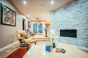 a living room with a stone wall and a fireplace at Fitzgerald House in Tampa