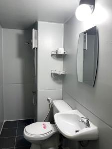 a bathroom with a sink and a toilet and a mirror at Impact Arena C3 Milo in Nonthaburi