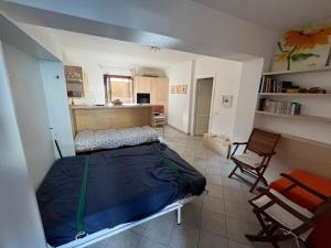 a bedroom with a bed and a table and chairs at Ampio monolocale in Golfo Aranci