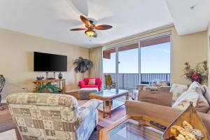 a living room with a couch and a ceiling fan at Shores of Panama #2302 by Nautical Properties in Panama City Beach