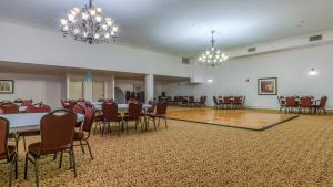 a banquet hall with tables and chairs and chandeliers at Shores of Panama #2302 by Nautical Properties in Panama City Beach