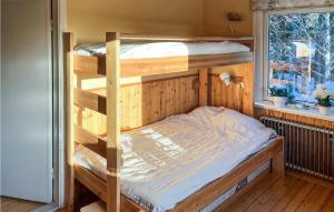 a couple of bunk beds in a room with a window at Amazing Home In Frnsta With Sauna, Wifi And 3 Bedrooms in Fränsta