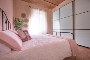 1 dormitorio con cama con almohada y ventana en Green Coast House 4, en Piombino