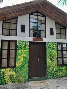a house with a painting on the side of it at The Room by Sarwaa in Varkala