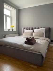 a bedroom with a large bed with three brown towels at Premium Apartment in quiet & historical area in Rīga