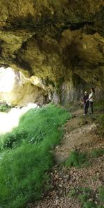 two people standing in a cave near the water at Xinaliq Qonaq Evi in Xınalıq