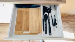 a drawer in a cabinet with utensils in it at Pod Świerkami in Boszkowo
