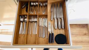 a wooden cabinet filled with lots of utensils at Pod Świerkami in Boszkowo