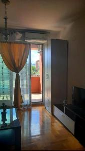 a living room with a large sliding glass door at Sunny Place in Ohrid