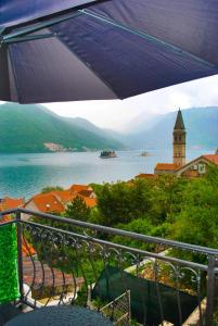 a view of a body of water with a clock tower at Apartment Mediterraneo Blue Sky in Perast