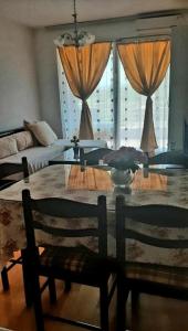 a living room with a glass table and two chairs at Sunny Place in Ohrid