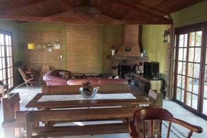a living room with a table and a couch and a fireplace at Casa ampla no Laranjal in Pelotas
