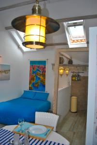 a living room with a blue bed and a table at Apartment Mediterraneo Blue Sky in Perast
