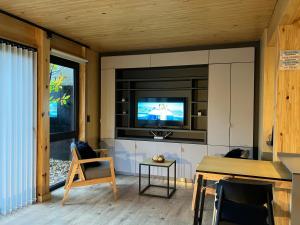 sala de estar con TV en la pared en HUEPIL, Monoambiente Centrico en San Martín de los Andes