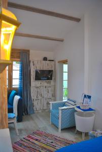 a living room with a couch and a tv in it at Apartment Mediterraneo Blue Sky in Perast