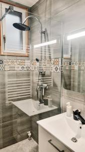 a bathroom with a sink and a shower at Balcon du Champ de Mars - Wifi / Parking in Angoulême