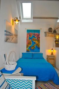 a bedroom with a blue bed and a map on the wall at Apartment Mediterraneo Blue Sky in Perast