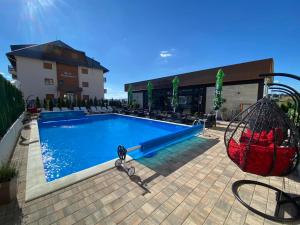 a swimming pool with a blue slide in front of a building at Spa & Wellness, apartman Sun & Snow in Zlatibor