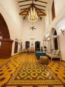 a large living room with a chandelier and a rug at The Postcard Saligao in Calangute