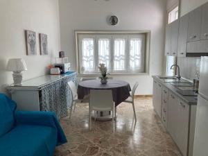 a kitchen with a table and a dining room at Casa Dalfea in Mazara del Vallo