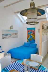 a living room with a blue bed and a table at Apartment Mediterraneo Blue Sky in Perast