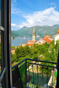 a view from a balcony of a town and a lake at Apartment Mediterraneo Blue Sky in Perast