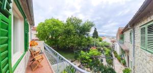 an apartment balcony with a view of a garden at Apartments Villa Rosa in Split