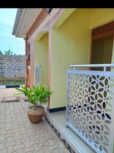 a porch of a house with a gate and a plant at MUSITA GUEST WING MOTEL 