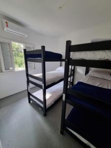 two bunk beds in a room with a window at Oh! Madalena Hostel in Sao Paulo