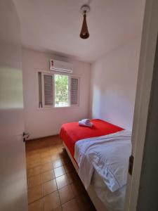 a bedroom with a red bed and a window at Oh! Madalena Hostel in Sao Paulo