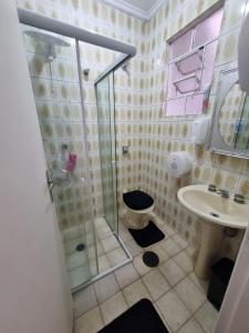 a bathroom with a shower and a toilet and a sink at Oh! Madalena Hostel in Sao Paulo