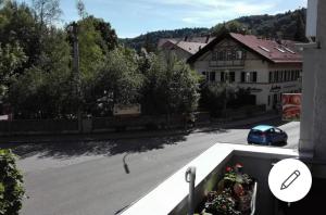 a car driving down a street with a building at Apartment mit 3 Zimmer in Wolfratshausen