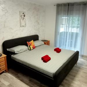 a bedroom with a bed with two red pillows on it at Sweet dreams in Alicante