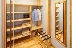 a walk in closet with a mirror and a ladder at Hotel Parque México Suites at Condesa in Mexico City